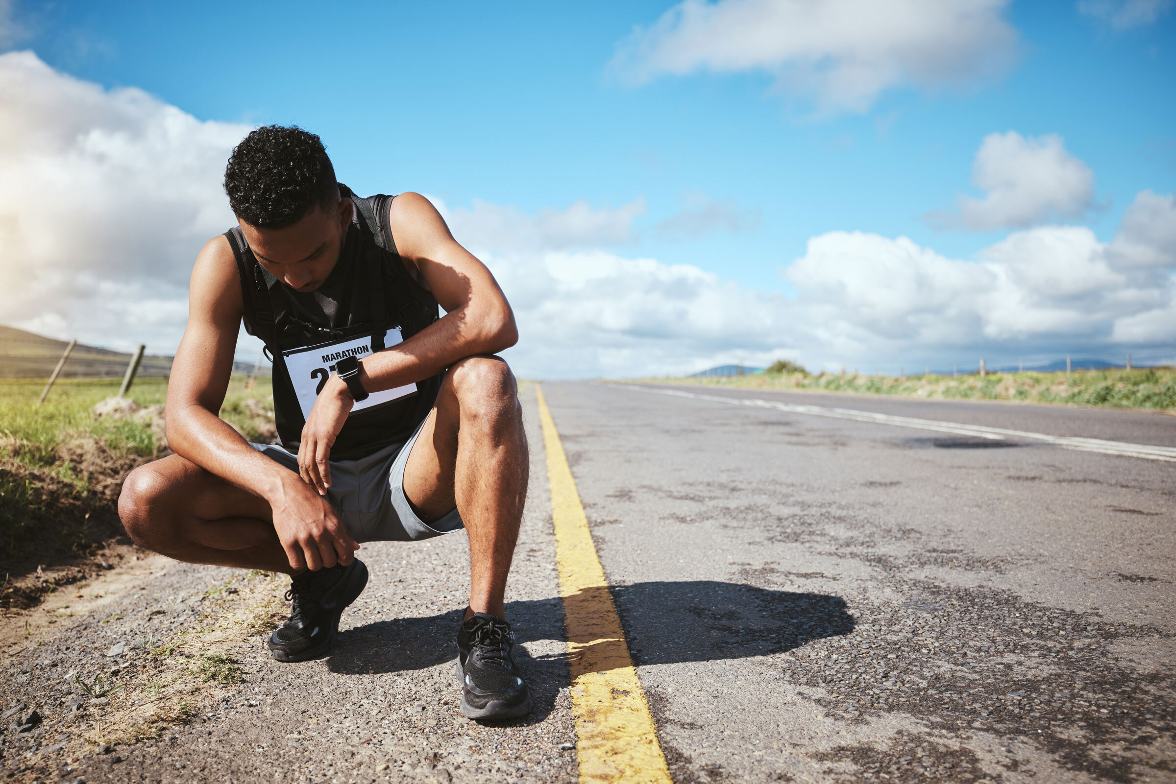 Exhausted runner kneeling down Exhausted runner kneeling down